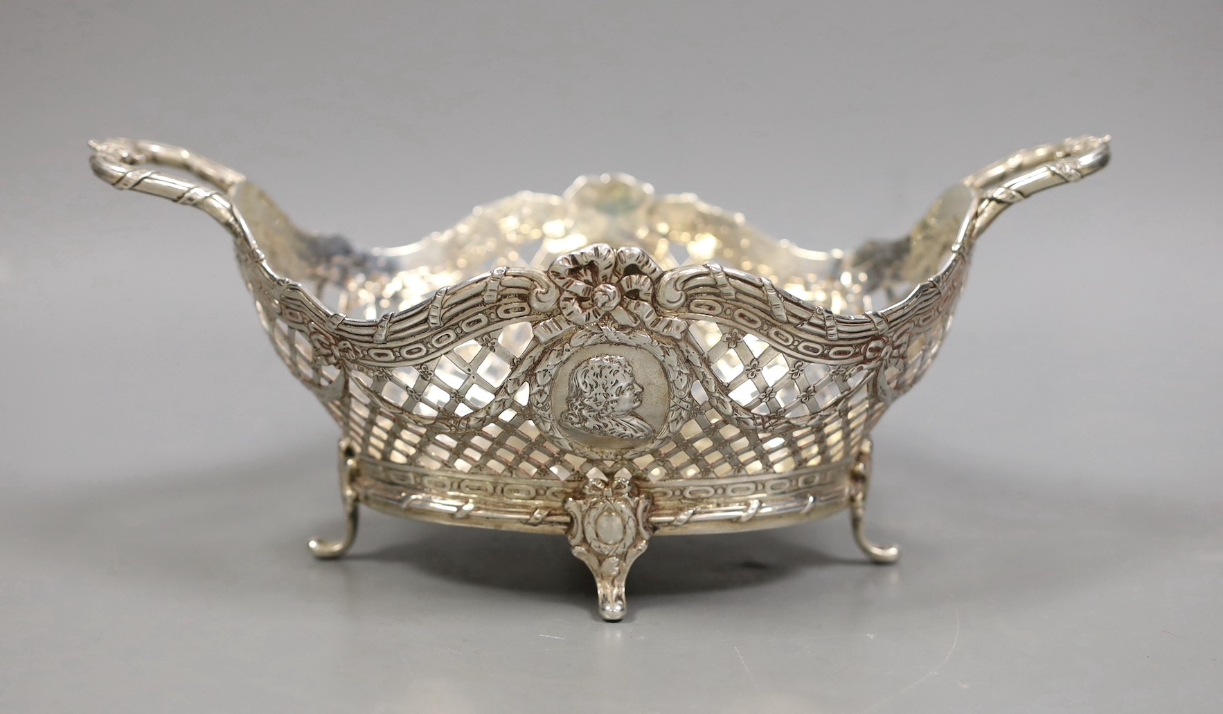 A late Victorian Hanau? pierced silver two handled bowl, embossed with busts, import marks for London, 1895, 25.7cm over handles, 14oz.